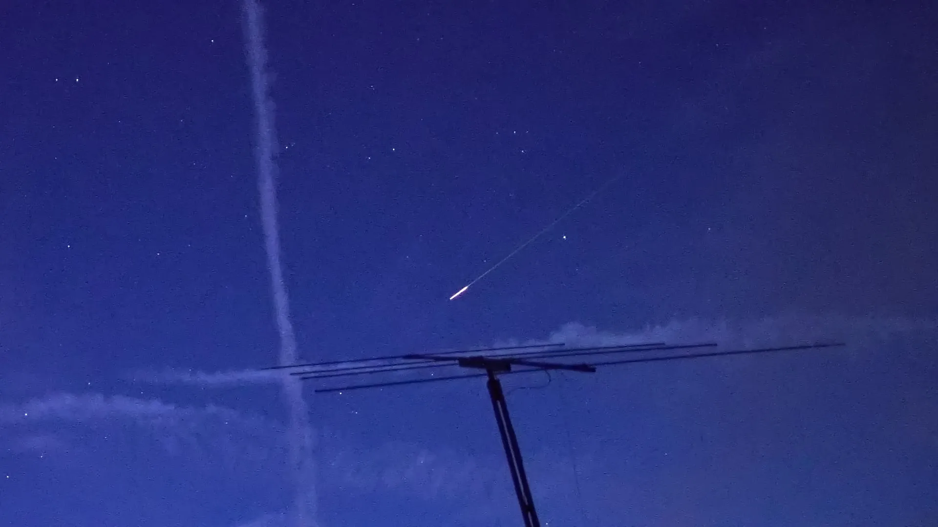 A meteor above a radio antenna